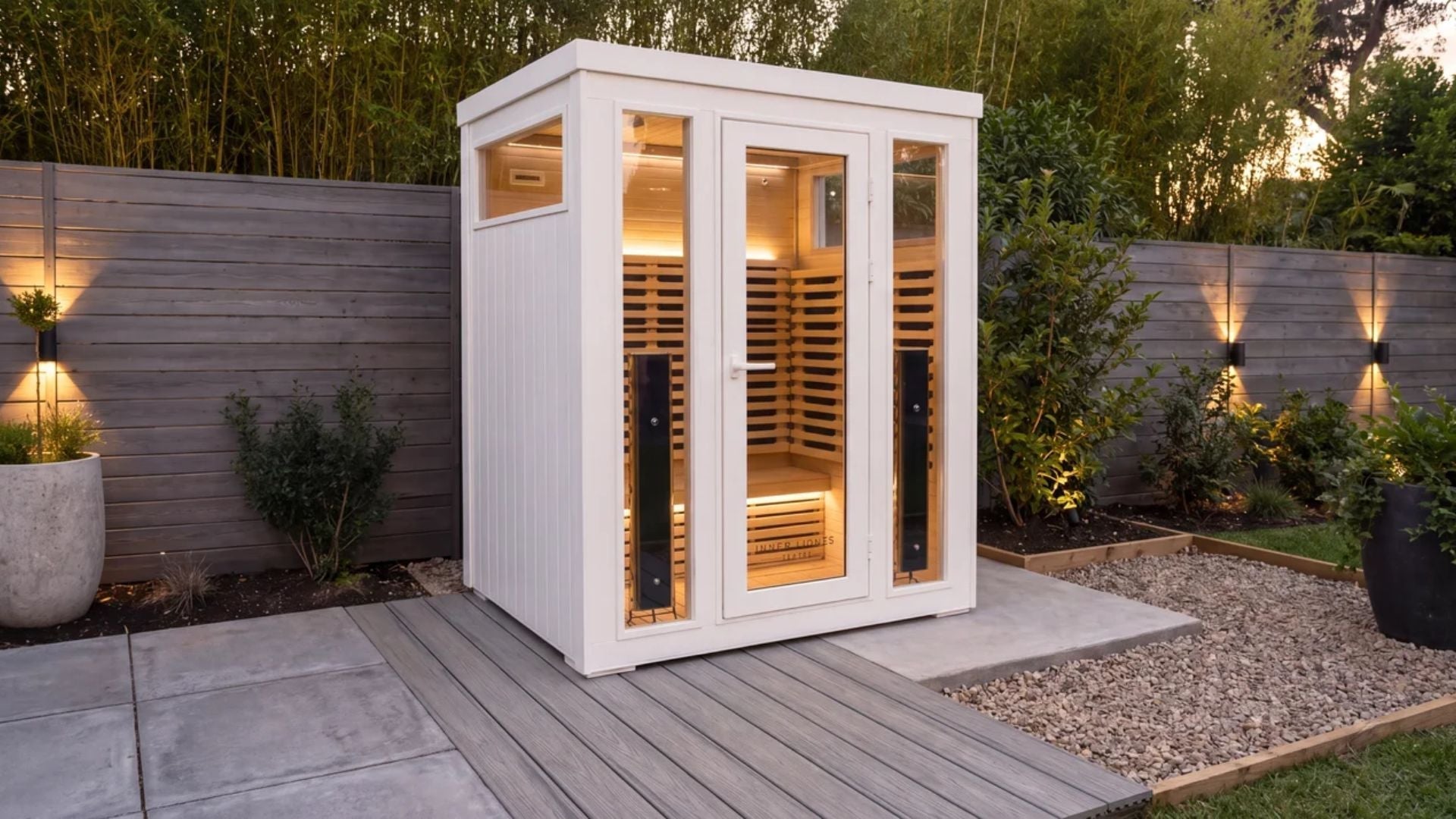 a white outdoor sauna placed on top of a concrete slab
