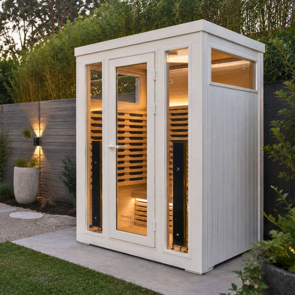 White outdoor infrared sauna in the garden. 