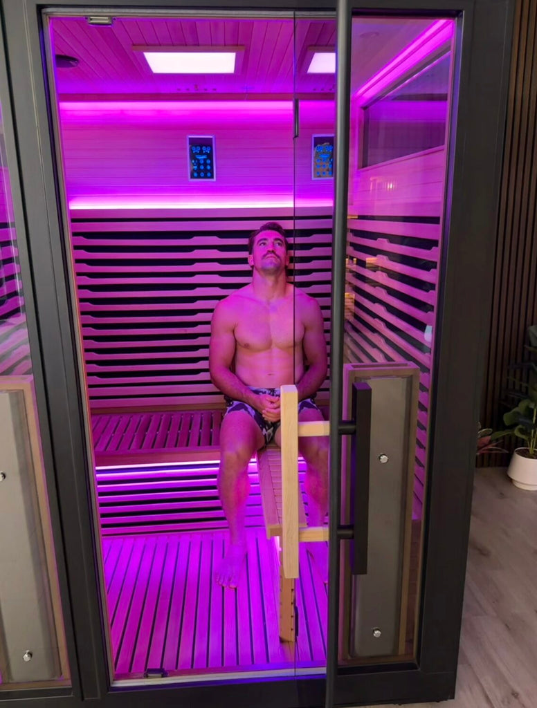 Connor Watson relaxing inside the Bella Deluxe infrared sauna with mood lighting